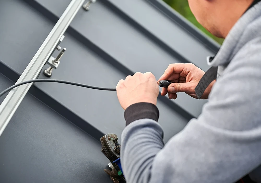 solar-panel-cabling Solar installer working on solar panel cable